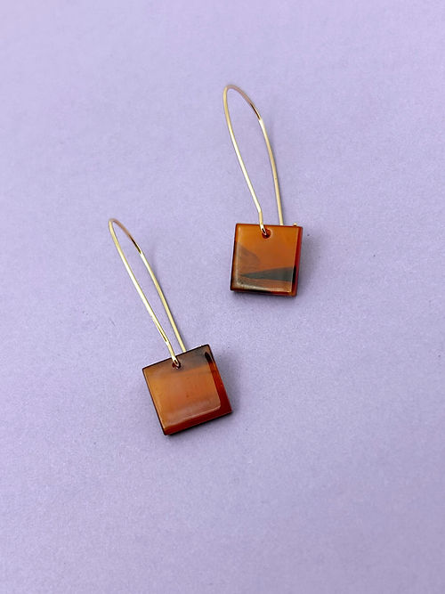 24k Gold Plated Amber Tortoiseshell Oval Hoops featuring elongated wire hooks with translucent amber square charms against lilac background. Minimalist modern design. By Aloe Earrings - Jewellery, Gifts Under £15, Gifts under £20, Earrings, Face, Aloe Earrings