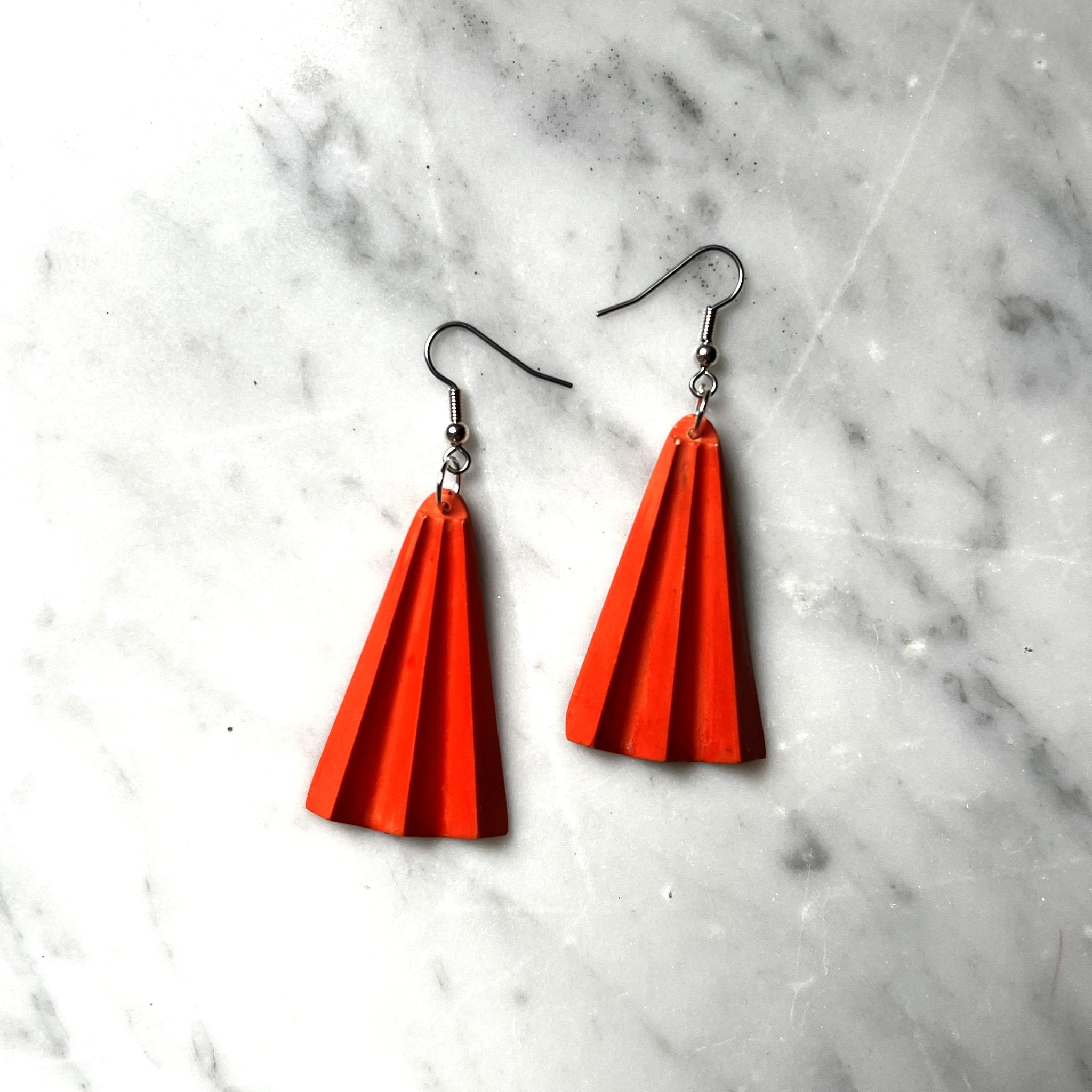 6049f0ff45e42d1cbc99c46b_sm-orangecoralfanearrings_1778663197003.png