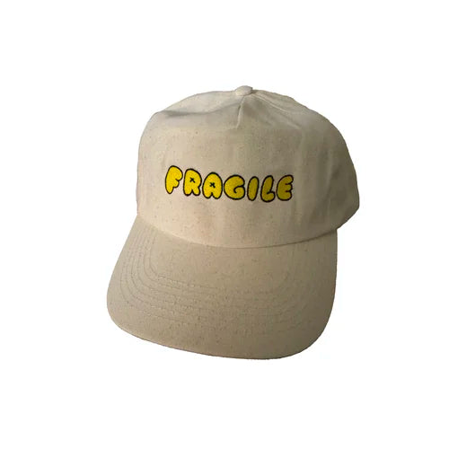 Beige cap with 'FRAGILE' text in yellow on a white background
