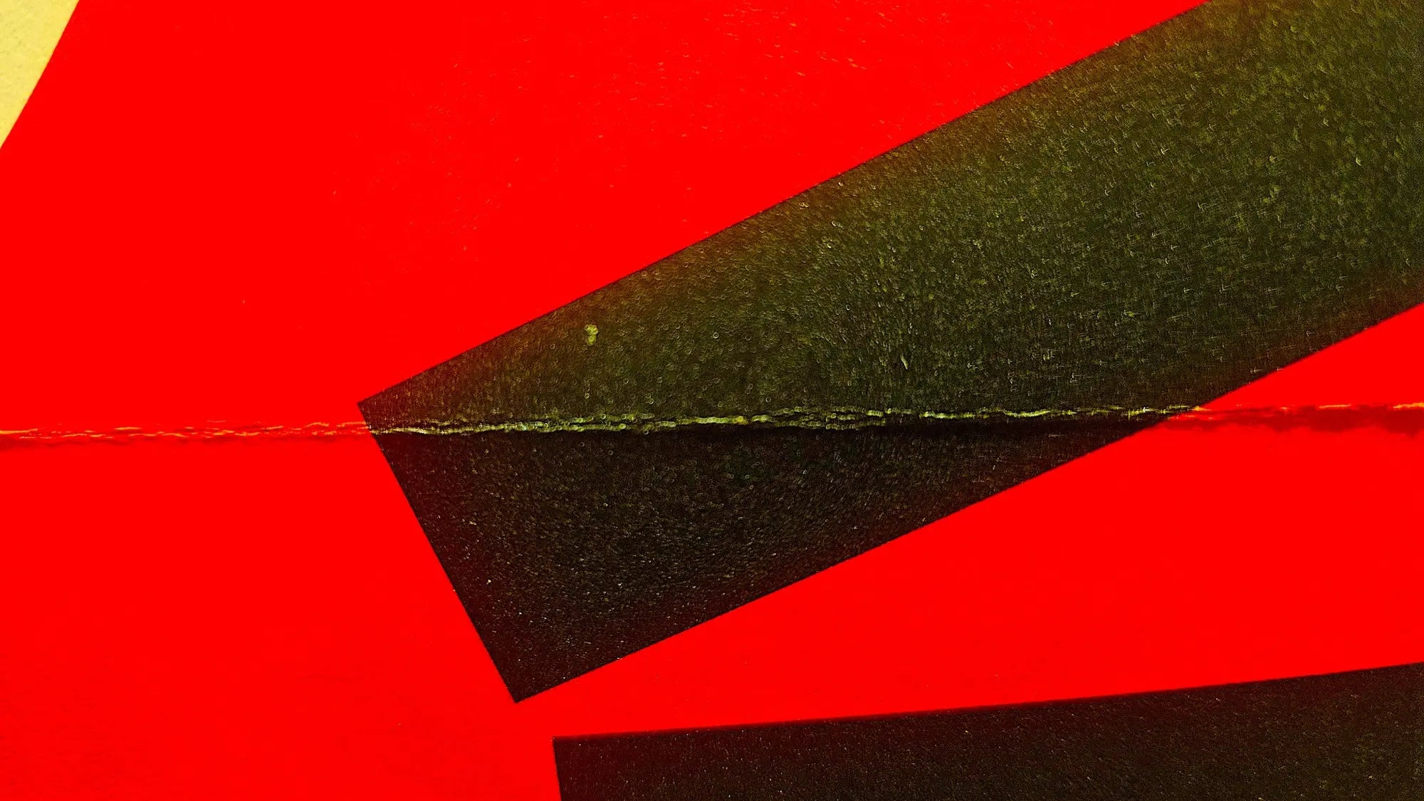 Close up of a red, black and yellow Posterzine cover by People of Print  