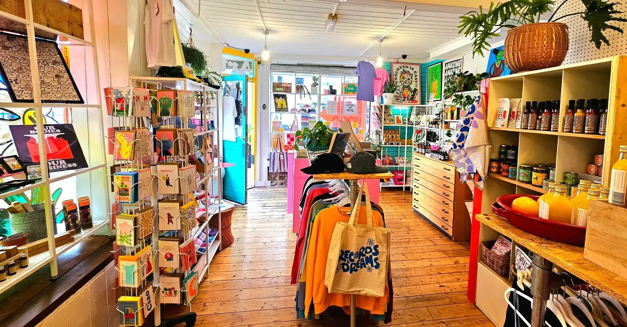 Bright and colourful Neighbourhood Store interior showing art prints, gifts, clothing and homewares displayed inside the shop