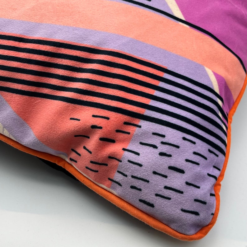 Geometric Pattern printed velvet cushion pinks/coral/lilac circle/black lines and stripes/cream