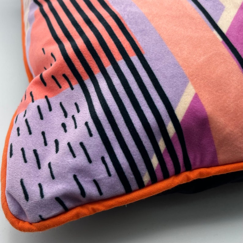 Geometric Pattern printed velvet cushion pinks/coral/lilac circle/black lines and stripes/cream